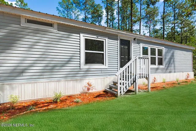 a backyard of a house with table and chairs