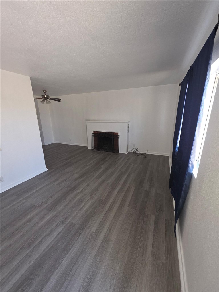 512 E Street Needles, CA 92363 - Photo 3 of 20 wooden floor in an empty room with a window