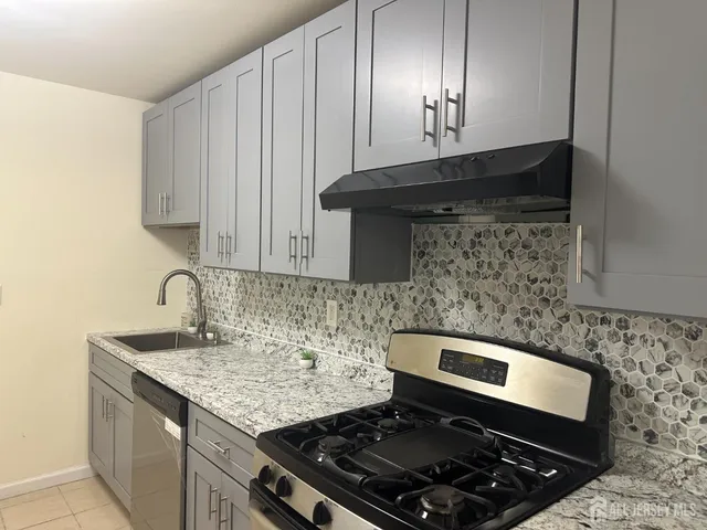 a stove top oven sitting inside of a kitchen