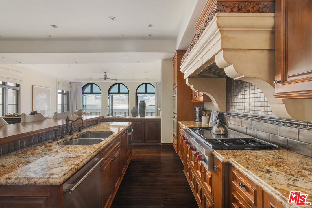 6209 Ocean Front Walk Playa del Rey, CA 90293 - Photo 13 of 57 a kitchen with granite countertop a stove and a sink