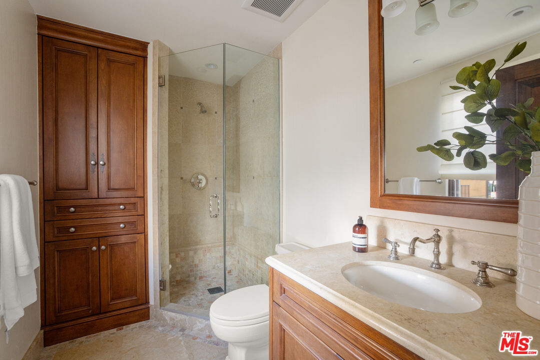 6209 Ocean Front Walk Playa del Rey, CA 90293 - Photo 22 of 57 a bathroom with a granite countertop sink toilet and shower
