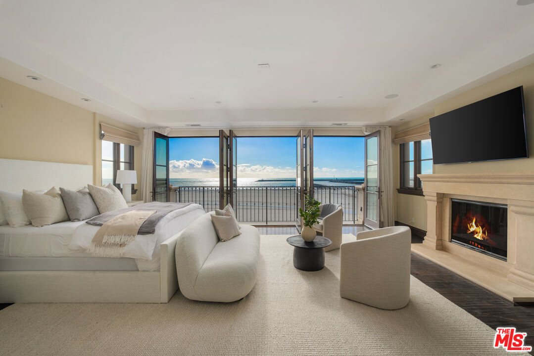 6209 Ocean Front Walk Playa del Rey, CA 90293 - Photo 28 of 57 a living room with furniture a fireplace and a flat screen tv
