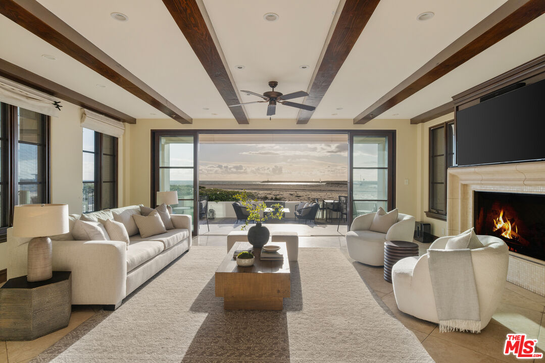 6209 Ocean Front Walk Playa del Rey, CA 90293 - Photo 35 of 57 a living room with furniture large window and a fireplace