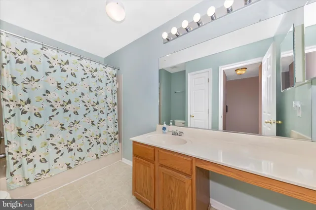 a bathroom with a bathtub sink and mirror