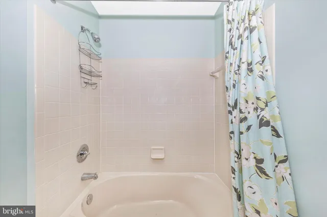 a bathroom with a bathtub and shower