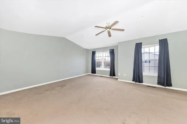 a view of a livingroom with a ceiling fan and window