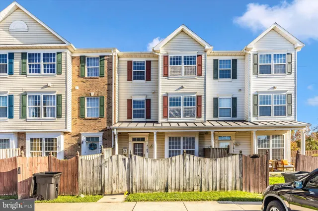 a front view of a residential apartment building with a yard