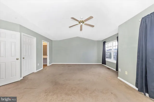 a view of a livingroom with a ceiling fan and window