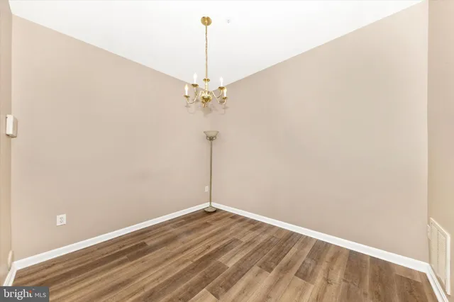 a view of a room with wooden floor and fan
