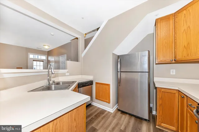 a kitchen with a refrigerator a sink and a window