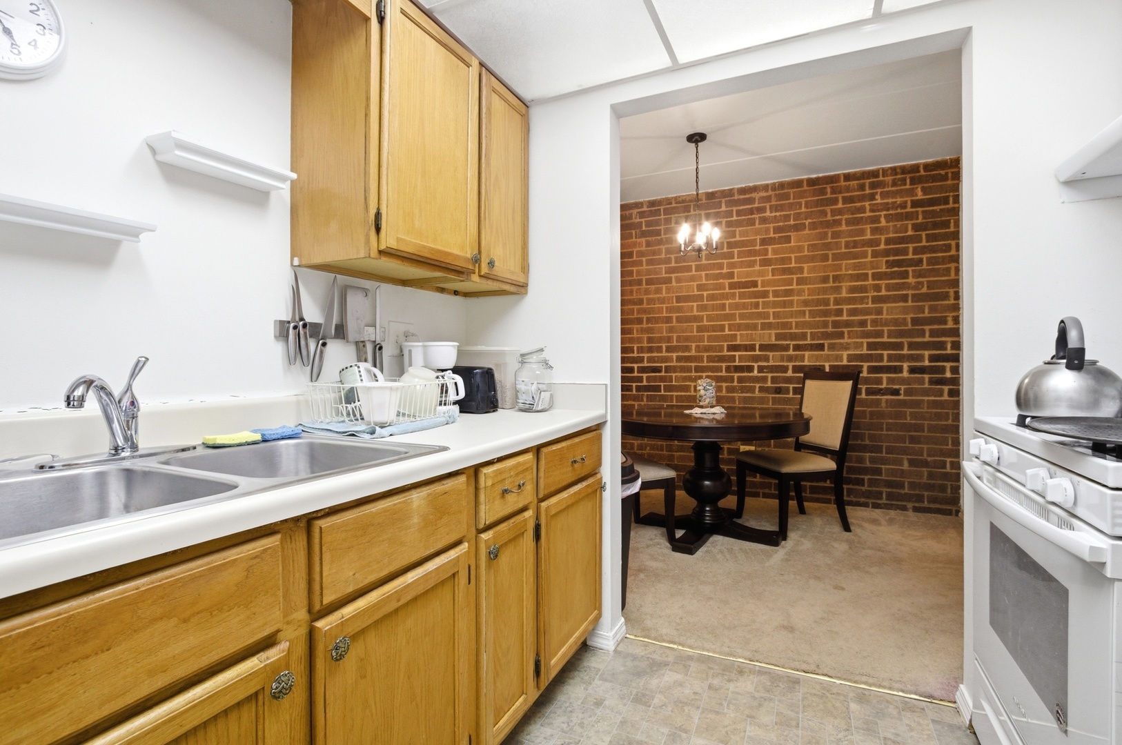 154 East Bailey Road, Unit D Naperville, IL 60565 - Photo 7 of 20 a kitchen with a sink cabinets and outdoor space