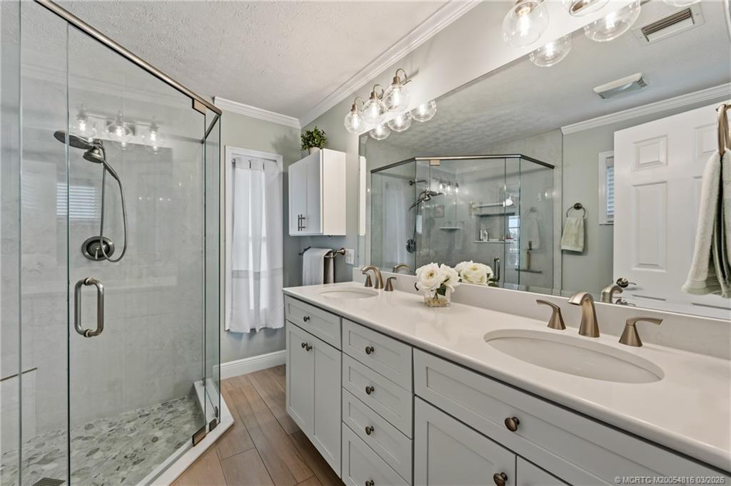 3160 Southeast Gran Via Way Stuart, FL 34996 - Photo 12 of 43 a bathroom with a granite countertop sink a shower and a mirror