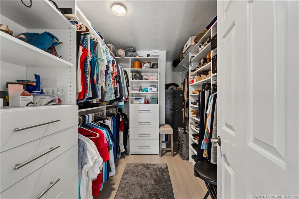 3160 Southeast Gran Via Way Stuart, FL 34996 - Photo 13 of 43 a view of walk in closet with clothes