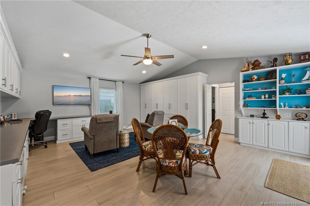 3160 Southeast Gran Via Way Stuart, FL 34996 - Photo 17 of 43 a view of a dining room with furniture and wooden floor