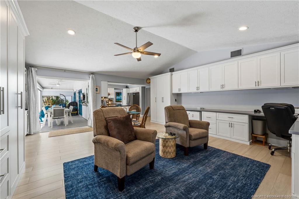 3160 Southeast Gran Via Way Stuart, FL 34996 - Photo 18 of 43 a living room with furniture a dining table and chairs with wooden floor