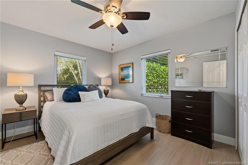 3160 Southeast Gran Via Way Stuart, FL 34996 - Photo 19 of 43 a bedroom with a bed and a closet