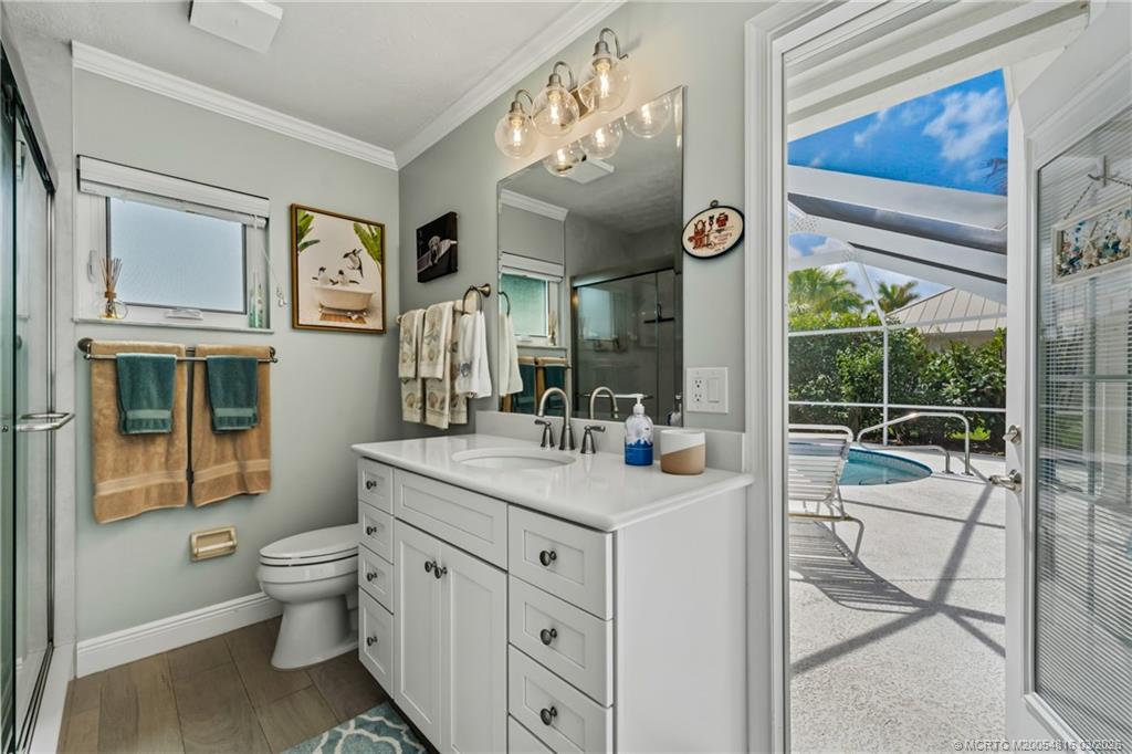 3160 Southeast Gran Via Way Stuart, FL 34996 - Photo 20 of 43 a spacious bathroom with a granite countertop sink toilet and a large mirror