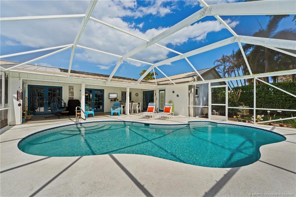3160 Southeast Gran Via Way Stuart, FL 34996 - Photo 23 of 43 a view of a house with backyard sitting area and porch