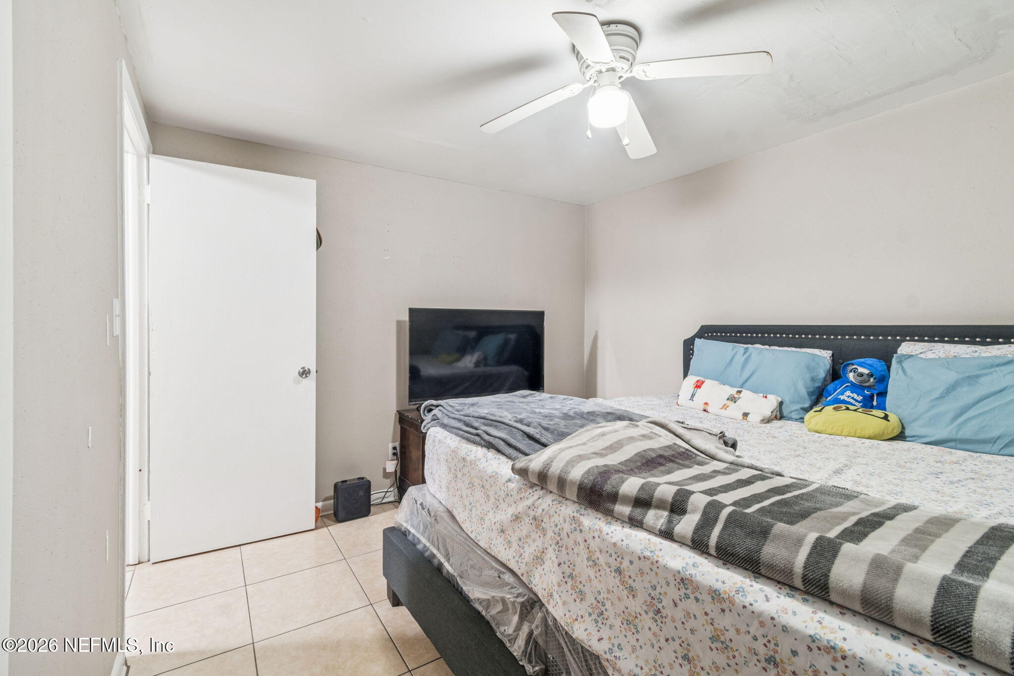 563 Eastport Road Jacksonville, FL 32218 - Photo 11 of 41 a bedroom with a bed and ceiling fan