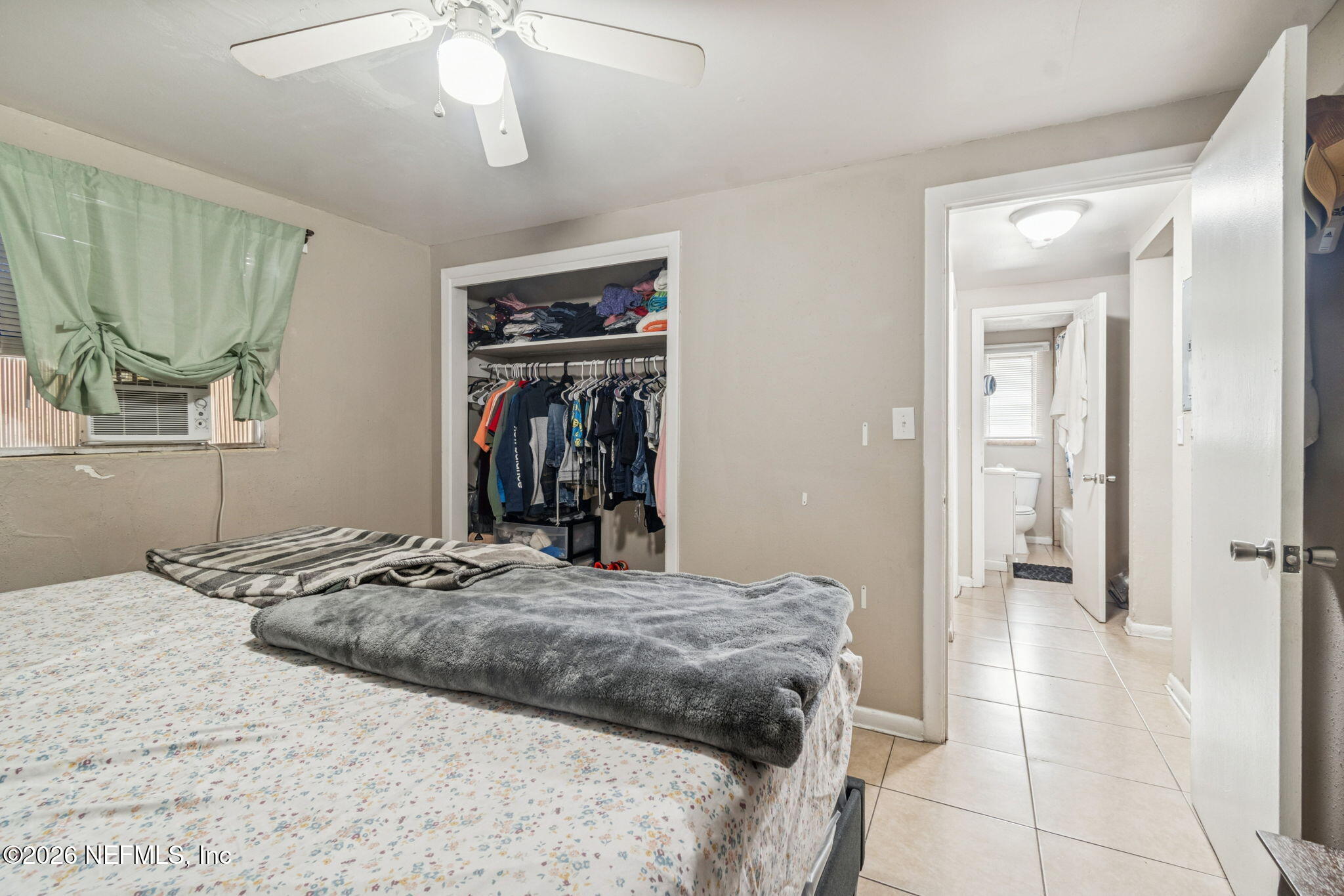 563 Eastport Road Jacksonville, FL 32218 - Photo 13 of 41 a bedroom with a bed and a mirror