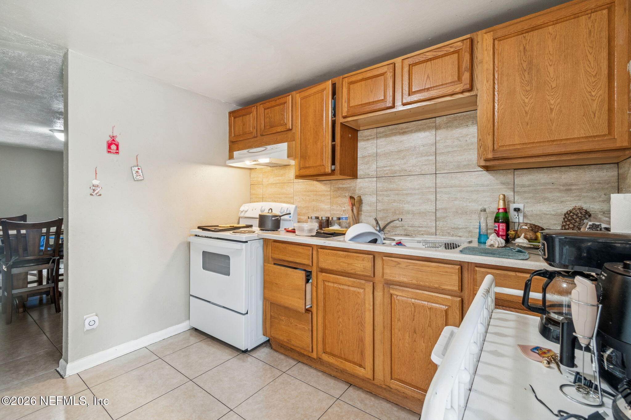 563 Eastport Road Jacksonville, FL 32218 - Photo 14 of 41 a kitchen with a sink cabinets and appliances