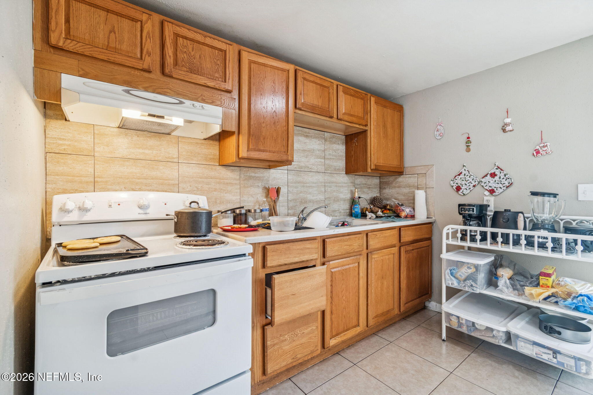 563 Eastport Road Jacksonville, FL 32218 - Photo 15 of 41 a kitchen with stainless steel appliances granite countertop a sink stove and cabinets