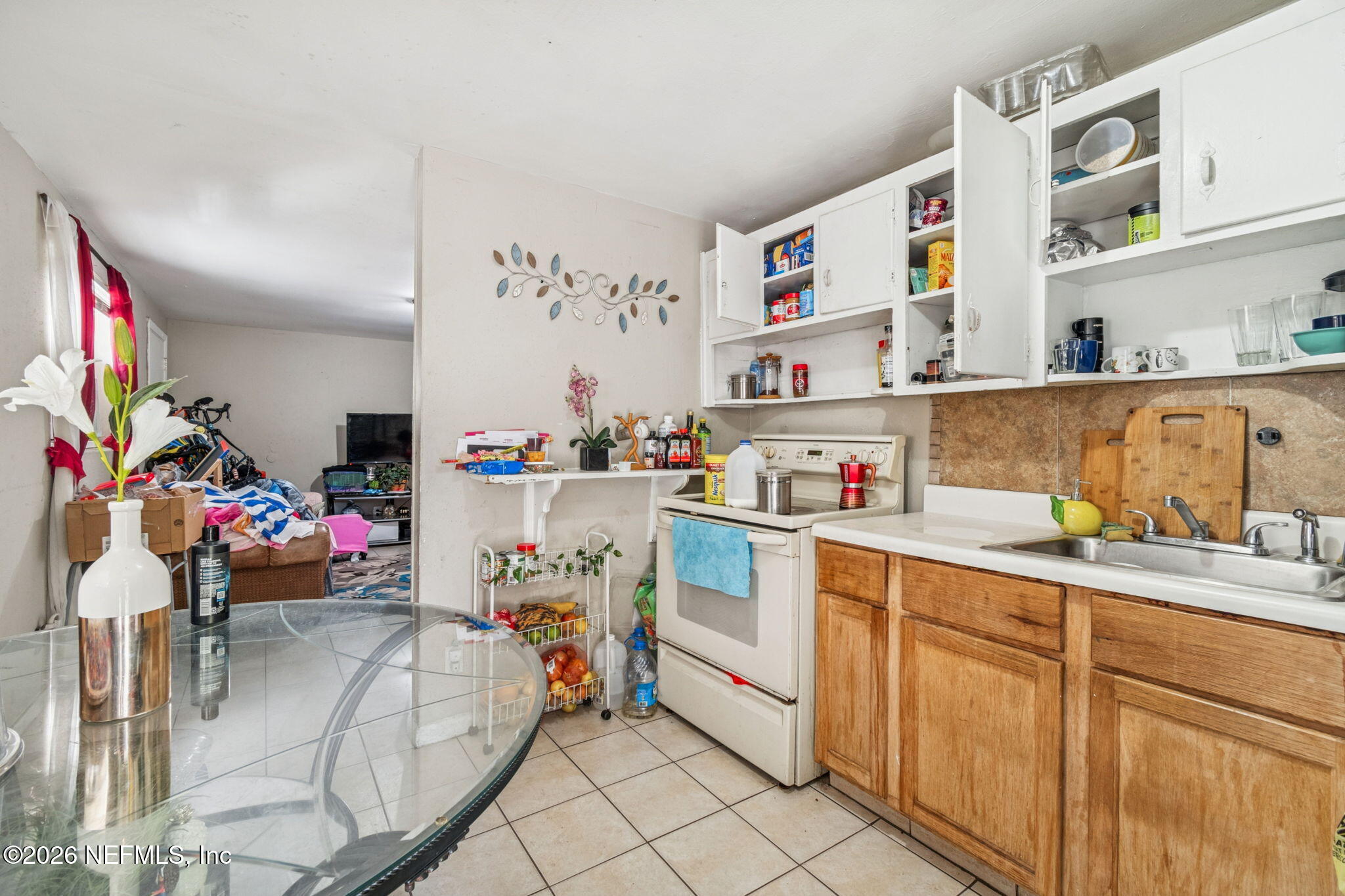 563 Eastport Road Jacksonville, FL 32218 - Photo 19 of 41 a utility room with stainless steel appliances lots of clutter and cabinets
