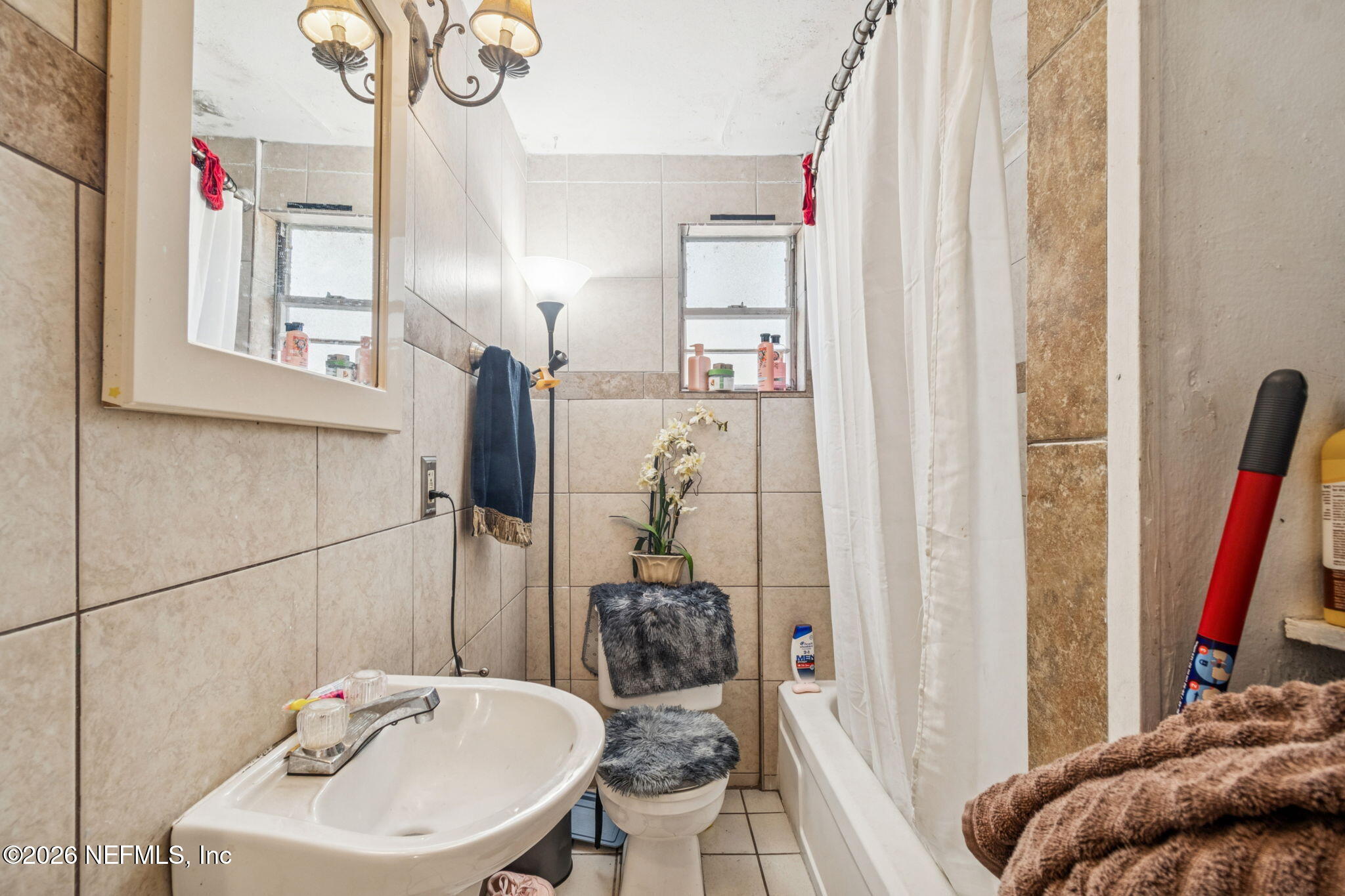 563 Eastport Road Jacksonville, FL 32218 - Photo 24 of 41 a bathroom with a sink and a mirror