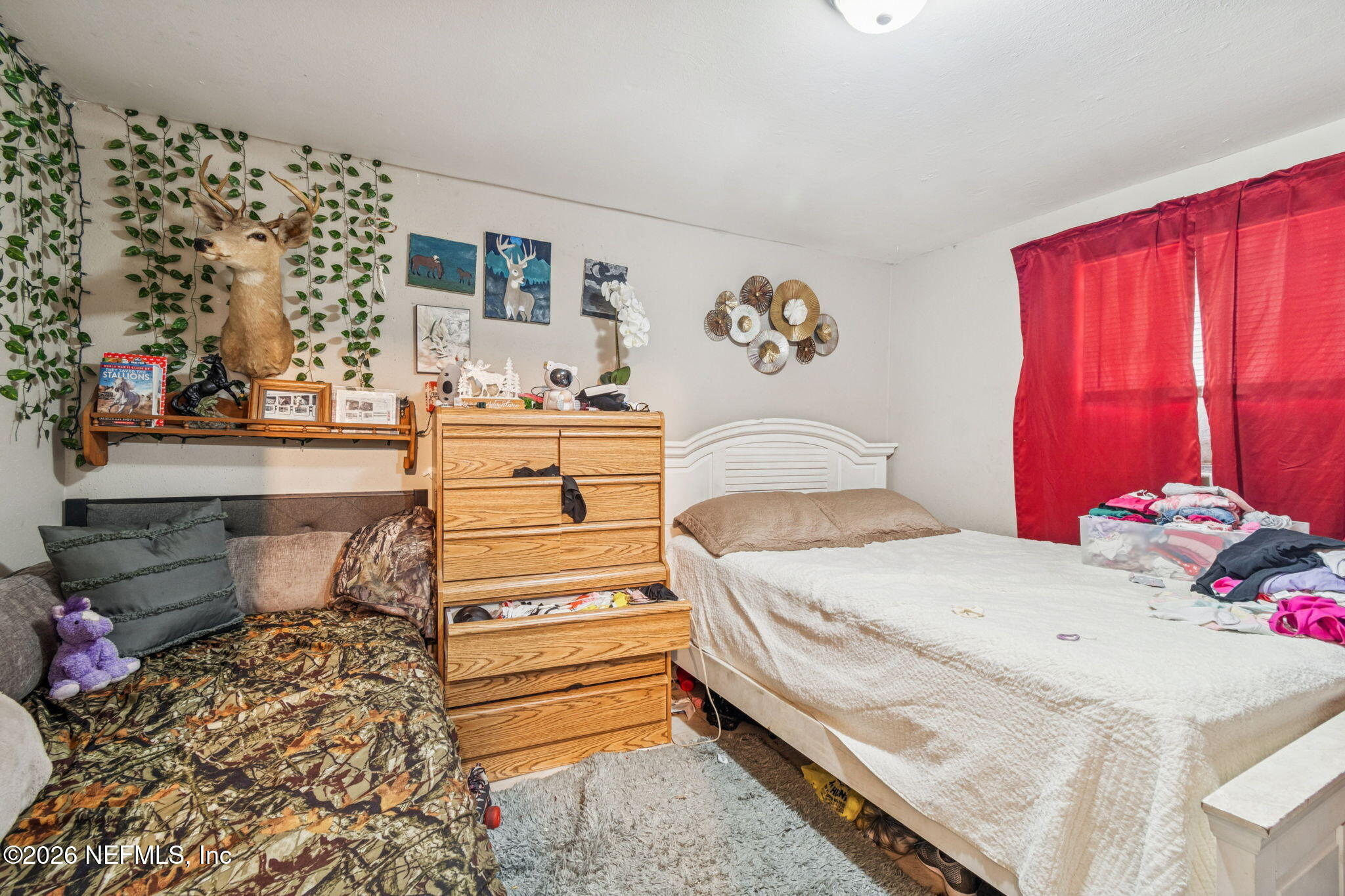 563 Eastport Road Jacksonville, FL 32218 - Photo 25 of 41 a bedroom with a bed and a window