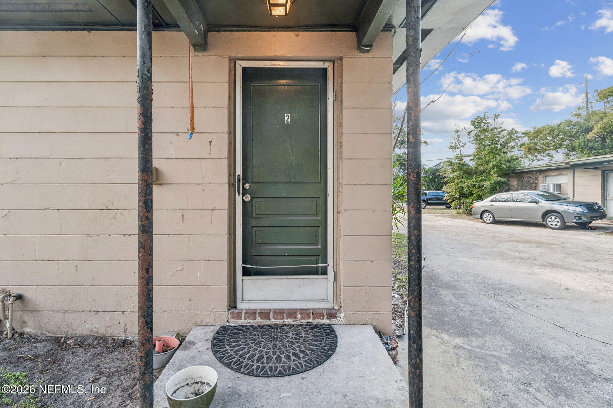 563 Eastport Road Jacksonville, FL 32218 - Photo 29 of 41 a view of a door and a car parked in front of house