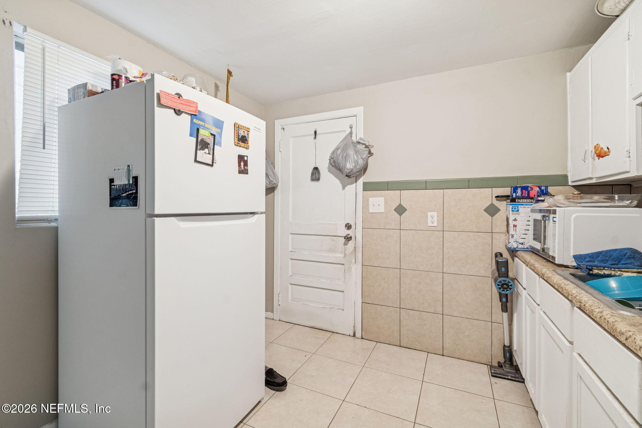 563 Eastport Road Jacksonville, FL 32218 - Photo 32 of 41 a white refrigerator freezer sitting inside of a kitchen