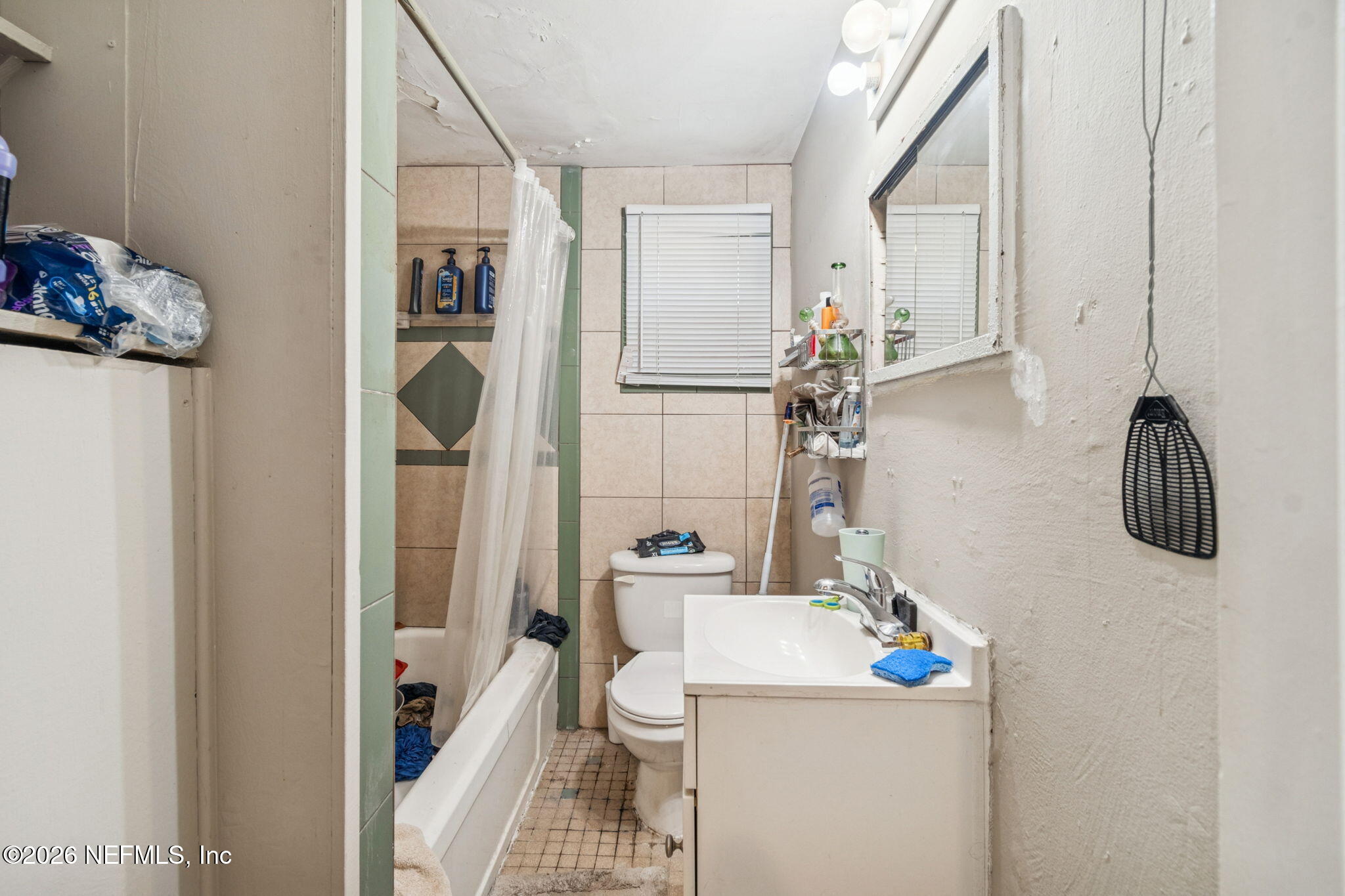 563 Eastport Road Jacksonville, FL 32218 - Photo 35 of 41 a bathroom with a sink a toilet and shower