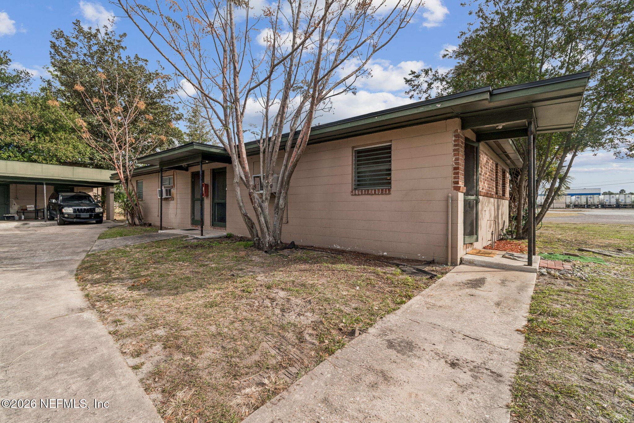 563 Eastport Road Jacksonville, FL 32218 - Photo 6 of 41 a backyard of a house with large trees and wooden fence