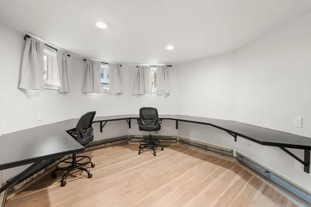 a view of a workspace with furniture and a window