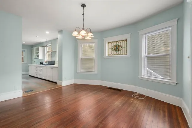 a view of a livingroom with furniture wooden floor and chandelier
