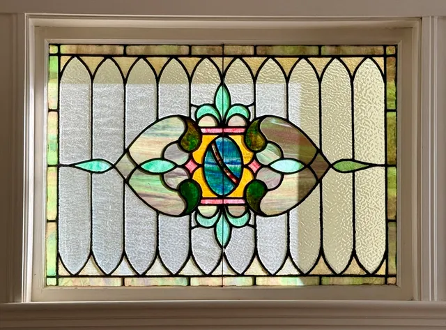 a picture of a glass door with a glass vase and next to a window