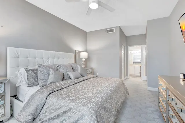 a bathroom with a bathtub shower sink mirror vanity and toilet