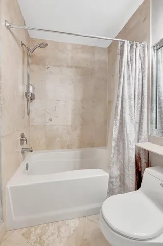 a bedroom with a bed and a mirror