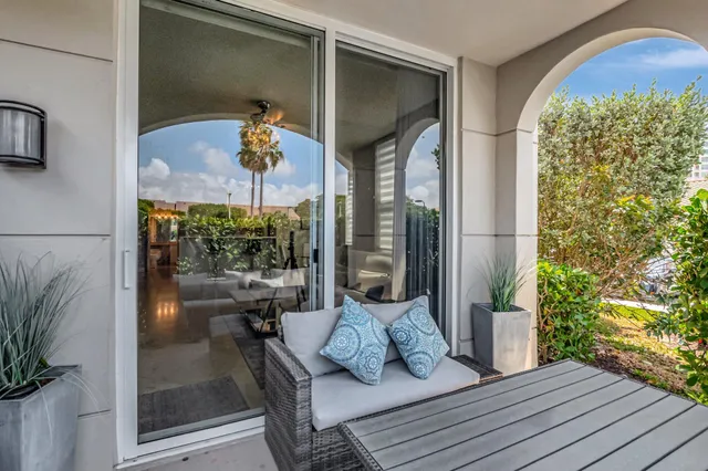 a swimming pool with outdoor seating and plants