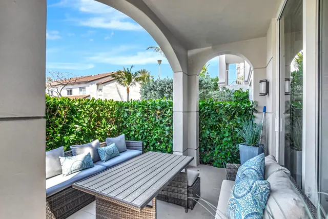 a view of a swimming pool with outdoor seating and plants