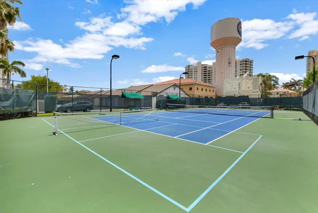 a dining room with furniture and large windows