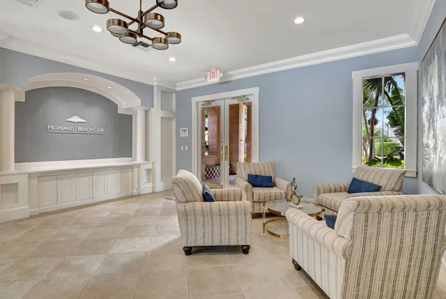 a room with pool table and windows