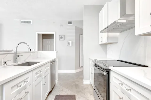 a kitchen with stainless steel appliances white cabinets and a stove