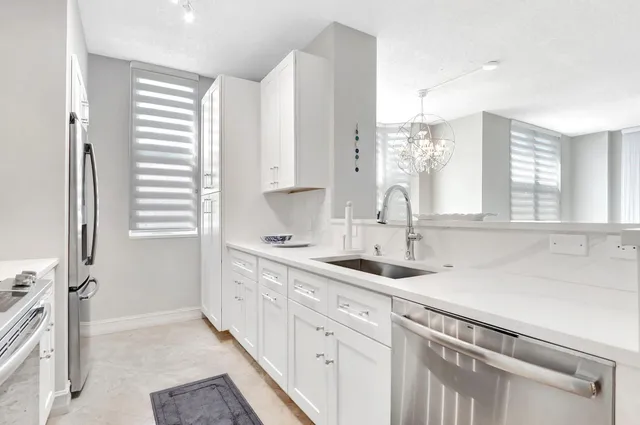 a dining room with wooden floor and chandelier