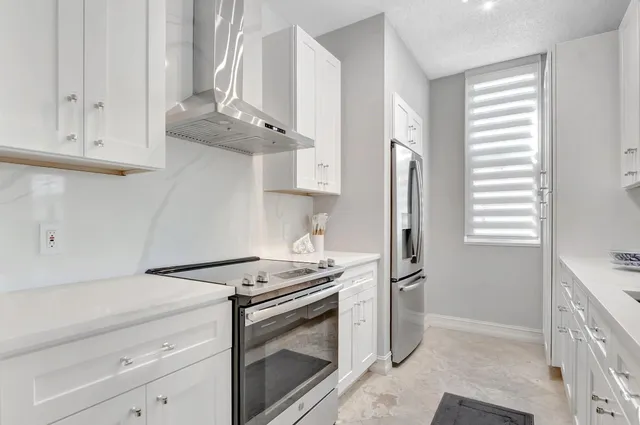 a living room with furniture and large windows