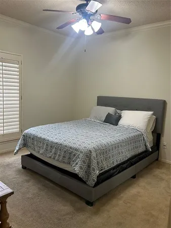a bedroom with a bed and window