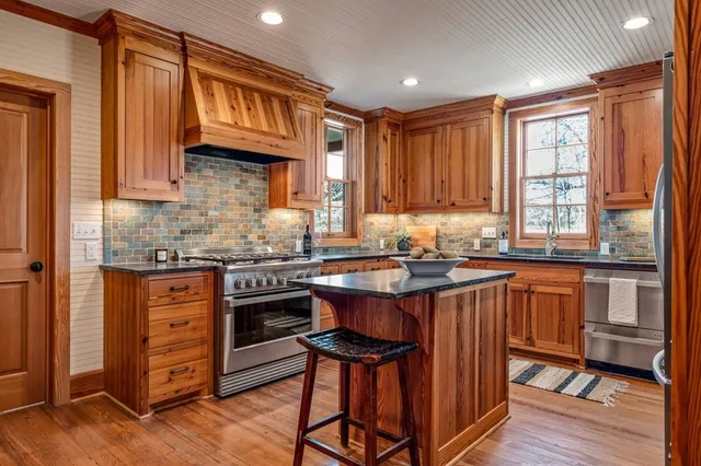 a spacious bathroom with a granite countertop sink a mirror and a shower