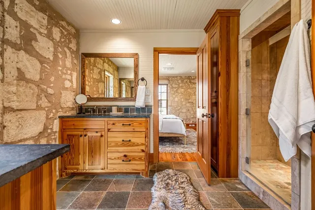 a bathroom with a sink a toilet and shower