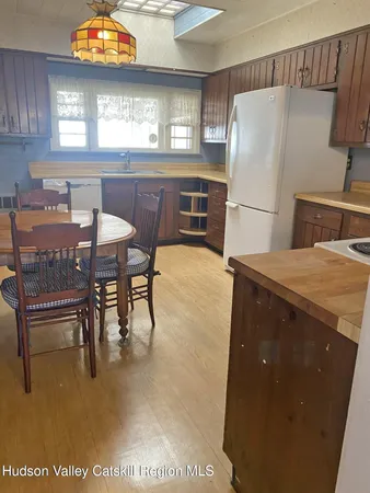 a bedroom with a bed and a dresser next to a window