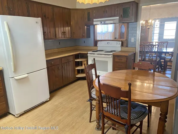 an empty room with wooden floor and window